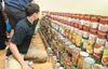 Academy Charter School eighth-grade student Gregory Martinez stacks Campbell’s soup cans to make the base of what will become a representation of Pioneer Peak Monday at Rusty’s at Dahlia Stre