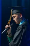 Knik Charter valedictorian Timothy Dyer shares his story during the graduation ceremony Thursday, May 15, at the Glenn Massay Auditorium. J. David McChesney/Frontiersman