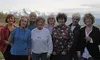 A longtime group of bridge-playing ladies smile for a photo at Linda Menard-Post's Lazy Mountain home on a breezy Tuesday evening. From left to right, back row: Linda Menard-Post, Rose Anders