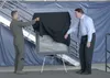U.S. Air Force Col. Robert Davis, 3rd Wing commander, and John Hume, an artist, reveal a commemorative painting during the opening ceremony for the 3rd Wing’s 100th anniversary celebration on
