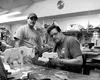 Fenton Woods owner Darryl Fenton shows off the pocket-sized Poop
Moose he is making for a comedy film called "Bachelorman," which
will be shot in Los Angeles next month. At left is shop forem