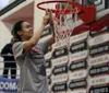 Wasilla junior Olivia Davies cuts down a piece of the net after the Warriors earned their fourth straight region title with a 55-28 win over Colony on the final day of the Northern Lights Con