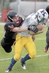 ROBERT DeBERRY/Frontiersman Houston defensive lineman Jake Davis
takes down Kodiak’s Chris Parsons during Friday’s game at Houston
High School. Robert DeBerry