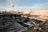 The iconic Palmer water tower stands in the background of the charred remains of one of the old Matanuska Maid buildings on the downtown Palmer property. Voters in 2010 gave city leaders the 