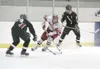 JEREMIAH BARTZ/Frontiersman Wasilla sophomore defenseman Michael
Johnston tries to move the puck past Houston'€™s Zack Wiesz during
high school hockey action at the Curtis C. Menard II Memori