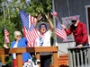 Wasilla Mayor Glenda Ledford, middle, waves to the crowd during the city of Wasilla's annual July 4 parade. Ledford was joined on the city's float by Joyce Lund, left, and Karl Lund, right, t