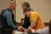 Michael Freeman does paperwork as part of his fingerprinting at the end of his Wednesday sentencing hearing. Freeman received a five year sentence with one year, six months suspended and five