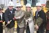Rep. Bill Stoltze, Mat-Su Borough Manager John Moosey, school district Superintendent Deena Paramo and Rep. Jim Colver send shovelfuls of dirt into the air with other members of the community