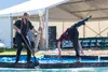 Lumberjack Derrick Knutson, left, looks on while Marvin Weeks plunges head first into the water. O'Hara Shipe - Shipe Shots Photography