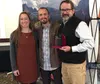 Kim Sollien, left, and Stuart Leidner, right, of the Mat-Su Trails and Parks Foundation accept the Northern Lights Award from Mat-Su CVB’s Justin Saunders. Courtesy photo
