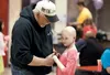 Ralph Holcomb talks with his granddaughter Alexia Faith Holcomb, 7, during Friday’s fundraiser at Tanaina Elementary. ROBERT DeBERRY/Frontiersman.com