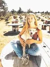 The blind teen-ager relaxes at her family kennel. Submitted
photo.