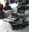 Israel Hale works on a lawn mower at Alaska Tool Doctor, the business he opened this spring. Despite the loss of his legs in an Anchorage accident about two and a half years ago, Hale has bee