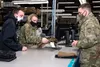 U.S. Air Force Col. Kirsten Aguilar, Joint Base Elmendorf-Richardson and 673d Air Base Wing commander, helps personnel assigned to the 773d Logistics Readiness Squadron issue equipment to Sol