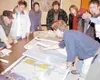 Chris Beck shows suggestions for incorporating subdivision plans
into borough land that would retain public use corridors wide
enough for motorized and nonmotorized uses. Photo by RINDI
WHITE