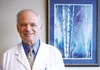 Dr. Michael Senta, general surgeon, stands by a painting his wife made, which hangs in his office at Mat-Su Regional Medical Center. Dr. Senta celebrates 35 years of medical practice in the V