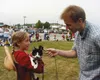 DANIEL SPOTH/Frontiersman Chris Cruthers, a volunteer for the
library, talks with the young owner of Katie the cat during the Pet
Parade.