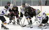 Houston forwards Yuriy Natekin (24) and Riley Scott (3) try to force the puck past Monroe goaltender Nate Jankowski during Monroe Catholic's 3-1 win over Houston in the ASAA/First National Cu