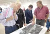 George Crowther, left, Maureen Stevenson, center left, and Dan
Kennedy, center right, listen to Wasilla's public works director
Archie Giddings talk about Wasilla's airport expansion Thursday