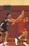 Houston's Roy Stull, left, and Wasilla's Ray Schaeffer, right,
square off in a battle of the two tallest players in the tournament
during Saturday's game in Wasilla. Photo by TIM
BRODT/Fronti