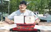 Shanon Cunningham proudly shows off his diploma, a citation from
the Alaska Legislature and the Presidential Educational Excellence
award he was given at his high school graduation Monday. Ph