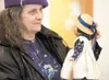 Amy Pettit-Ruby inspects a collectible porcelain doll Saturday at the Valley Community for Recycling Solutions doll sale. The event continues today from noon to 4 p.m. Robert DeBerry
