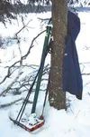 Gear used for a winter camping trip rests against a tree, as
fresh snow covers most of it. Using cross-country ski poles and
snowshoes is one way to enjoy the backcountry during the winter.
D