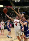 Houston's Cole Taylor tries to beat a pair of defenders to the basket during a loss to Nome. Bruce Eggleston/matsusports.net