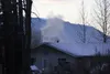Smoke pours out of a stove-pipe style chimney in a house along Bodenburg loop Tuesday. Officials say without a sustained public effort in 2016, the borough and state could be forced to spend 