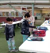 Nadine Drayton helps her children Trinity Mann and Justice Drayton pick out free backpacks. Jacob Mann/Frontiersman