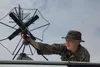 Marine Corps Lance Cpl. Nicole Pam Penwarden, a communications specialist with Humanitarian Assistance Survey Team, Combat Logistics Battalion 24, 24th Marine Expeditionary Unit, sets up a sa