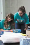 Sierra Fox of Kipnuk and Amanda Kimpton of Wasilla calculate material costs for creating a swatch of puncture-proof material for a Spacesuit Challenge at the Bernard Harris Science Camp on Ju