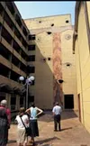 Doug Tescher, Katelyn Baldwin, Elizabeth Skirving and Susan
Gunther, stare in awe at the attacks made to Rwanda's Parliament
building in the 1994 genocide. The building has yet to be repaired