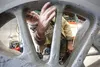 Ron Dudley shows where oil began leaking on one of the drivers of Engine No. 557 after being sandblasted. ROBERT DeBERRY/Frontiersman