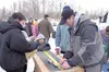 Butch Ehmann takes a measurment of a fish caught during the Ehmann’s Outdoors Mat-Su Kids Ice Fishing Derby. Courtesy Jehnifer Ehmann