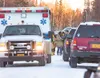 Karen Walters, 53, is escorted to a waiting Mat-Su Borough
ambulance Saturday afternoon at the scene of a shooting and alleged
home invasion on Wolverine Drive. ROBERT DeBERRY/Frontiersman