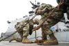 Army Sgt. Dylan Knigge, left, and Specialist Timothy Burns, both assigned to the 109th Transportation Company, 17th Combat Support Sustainment Battalion, U.S. Army Alaska, secure U.S. Marine 