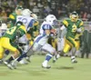 ROBERTDeBERRY/Frontiersman Moose running back Shannon Sawyer
breaks through the Cougar defensive line during Friday's game at
the Anchorage Football Stadium. The Moose defeated the Cougars
28