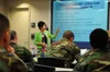 Beth Juachon, a VA military services coordinator, explains details of the Montgomery G.I. Bill for active-duty service members to Naval Special Warfare Sailors at Naval Amphibious Base, Coron