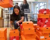 Mat-Su Sea Hawkers volunteer Miss Alaska Larissa Shcierholt sorts through Nike shoes to hand out. This event was at Grizzly Family Fitness on the Palmer-Wasilla Highway Feb. 28, 2025. J. Davi