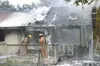 Firefighters put out a blaze off Bogard Road on Thursday. The
fire started in a back bedroom, reportedly when a toddler knocked
over a candle. TODD L. DISHER/Frontiersman
