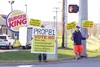 Wasilla residents Tel White, left, and Sam Ouellette urge passersby to 'Vote No' on Proposition B-1 — a 'yes' vote would prohibit marijuana commercialization in unincorporated areas of the Ma
