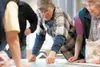 Jim Page points to what he considers potential problems with the third phase of a state Department of Transportation Parks Highway plan from Pittman Road to Big Lake Road during an open house