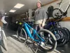 An employee of Alaska eBike in Anchorage stands next to an electric bicycle in early 2023. The Alaska Legislature has voted to approve a bill deregulating e-bike use.  Sophia Carlisle/Alaska 