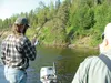 An angler fights his first king salmon under the guide's watchful eye during a charter on the Deshka River. Courtesy of Howard Delo