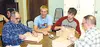Palmer Pioneer Home residents Thurston Dobson, left, and Bob
Dobson, right, sand their shadowboxes with Palmer High School
students Joe Foxley and Mark Psenak Wednesday afternoon.CASEY
RESSLE