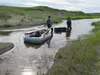 Chris Maio (in green) and graduate student Reyce Bogardus pull a sediment core from a lake near Cape Espenberg. Photo by Nancy Bigelow.