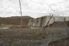 A dilapidated fence hangs in front of the missile launch and storage area at Nike Site Summit, at Joint Base Elmendorf-Richardson, Alaska, Sept. 9, 2017. Nike Site Summit was constructed in 1