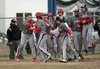 The Houston Hawks celebrate as senior Hayden Chivers crosses home plate after hitting the go-ahead two-run home run during a 10-7 win over the Palmer Moose Wednesday, May 10, 2018, in Palmer.