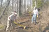 TODD L. DISHER/Frontiersman David Heck, right, and Dave Werner,
left, work on a new section of trail around Long Lake with other
members of the Valley Mountain Bikers and Hikers on Sunday.